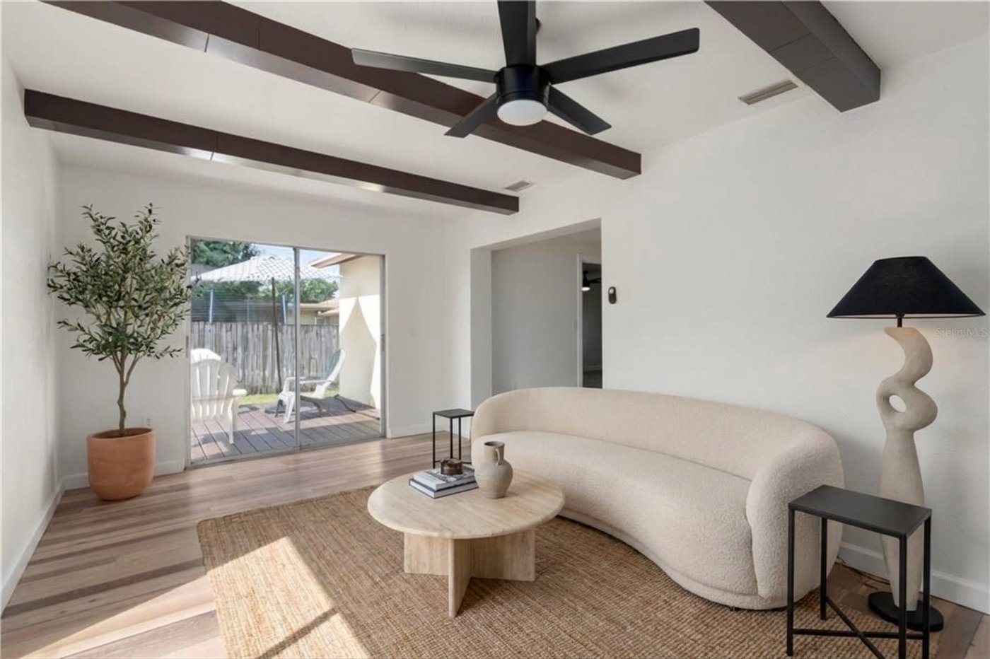 The same living room staged in a modern Florida style as an AI concept
